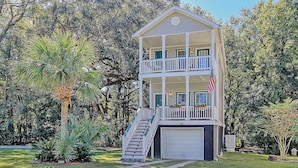 A two-story house with a balcony, a garage, and a well-maintained lawn. - Centrally located to Charleston’s best! (North Charleston)