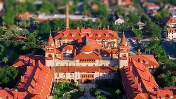A large, historic building with multiple towers and a central courtyard.