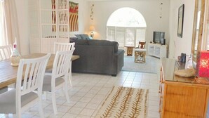 A living room with a sofa, chairs, a coffee table, and a TV. - Avenida San Valle, Sabino Canyon (Tucson)