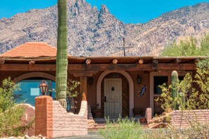 A rustic building with a wooden facade, a prominent cactus in front, and a mountainous backdrop. - Quintessential Tucson Foothills Retreat with pool (Tucson)
