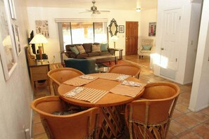 A dining area with a round table, chairs, and a ceiling fan. - Redington Hideaway with sweeping views (Tucson)