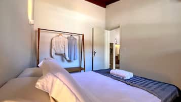 A hotel room with a bed, a wardrobe, and a mirror.
