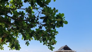 A beach with a wooden pier leading to a thatched-roof structure. - Pamana Beach House  (Calatagan)