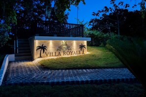 Enter a luxurious haven marked by a regal entrance and paved pathway.