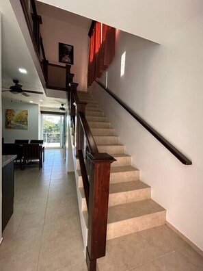 A staircase with wooden handrails leading to an upper floor. - Tropical 2BR Villa with Private Plunge Pool (First Bight)