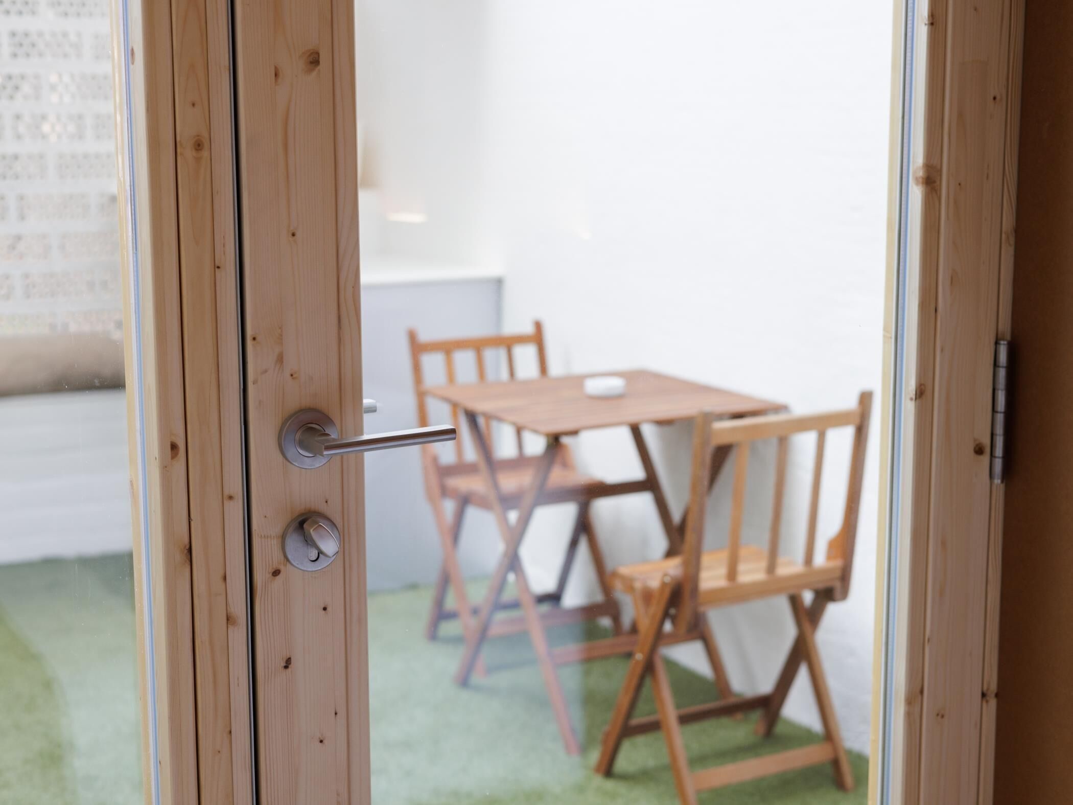 A wooden door with a handle, a keyhole, and a lock.
