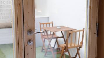A wooden door with a handle, a keyhole, and a lock.