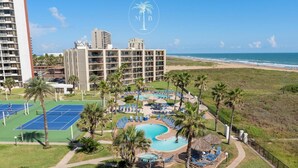 A hotel with a pool area, tennis courts, and a beach view. - Luxury beachfront condo with the best ocean view! (South Padre Island)