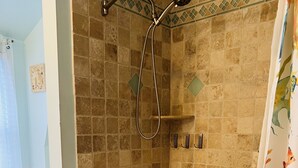 A bathroom with a bathtub, shower, and toilet. - Cozy beach-inspired home! Close walk to boardwalk and beach! (Ocean City)