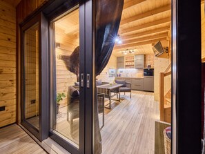Relax in a spacious room with a large sliding glass door leading to a cozy seating area and a comfortable sofa.