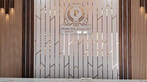 A reception area with a marble floor, a decorative ceiling, and vertical wooden panels. - Prime beach resort  Mandarmani (Kanthi)