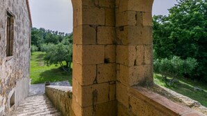 An arched stone structure with a view of a green landscape. - Il Piccione by Interhome (Pitigliano)