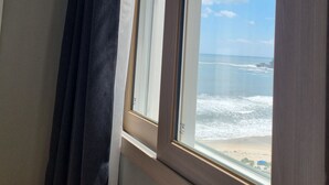 A window with a view of the ocean and beach. - 환상적 전면 오션뷰/일출 성지/죽도 해변/인구 해변/서핑 성지/물놀이 (Yangyang)