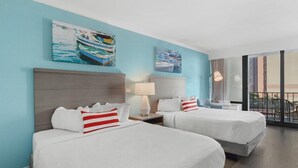 A hotel room with two beds, a large window with a view, and artwork on the walls. - Coastal Serenity: Partial Ocean View Room 1st Flr (Myrtle Beach)