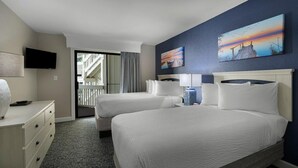 A hotel room with two beds, a flat-screen TV, a desk with a lamp, and artwork on the walls. - Relaxation by the Beach: 2BR with Resort View (Myrtle Beach)