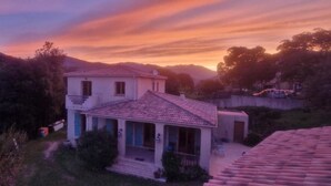 A two-story house with a tiled roof, surrounded by greenery and hills. - Villa 10 Personnes au Calme Entre mer et Montagne. 5 Chambres, 5 Salles de Bain (Vico)