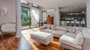 A spacious living room with a large sectional sofa, a gold-framed chaise lounge, and a wooden floor. - Villa with private pool in The Tuscan Countryside (Figline e Incisa Valdarno)