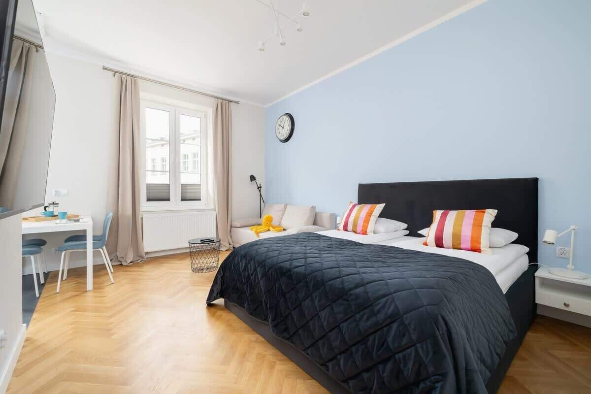 Un dormitorio con una cama grande, un escritorio y una silla.