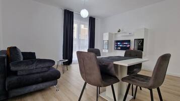 Superior Apartment | Living area | 108-cm flat-screen TV with cable channels, heated floors