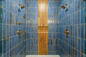 Bathtub, towels, shampoo, toilet paper