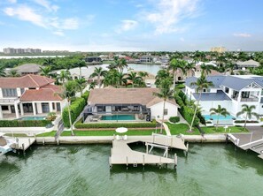 A residential area with houses, a dock, and a body of water.