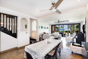 Relax in a spacious room with a dining area, seating area, and balcony offering ocean views.