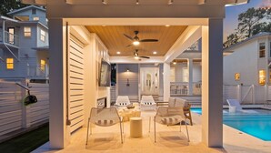 An outdoor patio area with a pool, seating, and a ceiling fan. - Outdoor Cabana with Pool and LSV (Santa Rosa Beach)