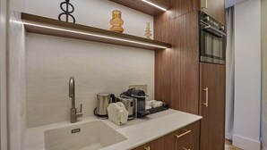 A modern kitchen with a built-in sink, stainless steel appliances, and wooden cabinetry.