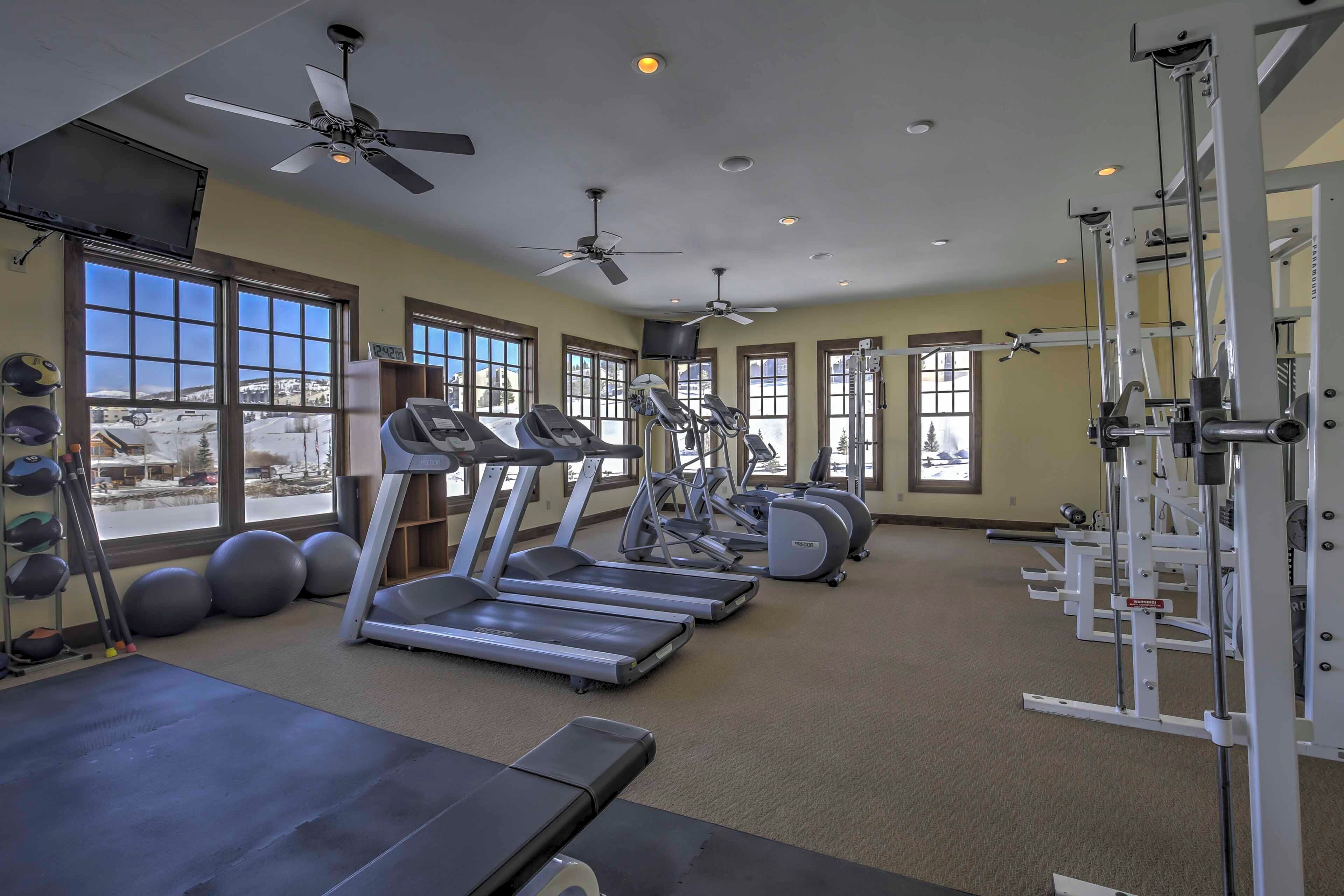 A gym with treadmills, elliptical machines, and weightlifting equipment.