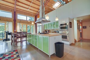 A spacious kitchen with a large island, modern appliances, and ample natural light.