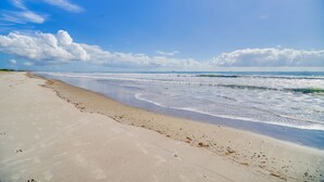 A beach with a sandy shore and waves. - Florida Retreat w/ Pool, Hot Tub & Beach Access! (Cocoa Beach)