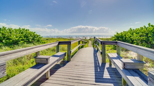 A wooden boardwalk leading to a beach with a clear sky and distant horizon. - Florida Retreat w/ Pool, Hot Tub & Beach Access! (Cocoa Beach)