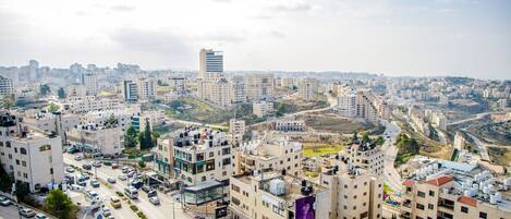 A cityscape with multiple buildings, roads, and vehicles.