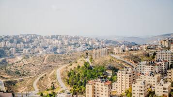 A high-rise residential area with multiple apartment buildings, winding roads, and hilly terrain.