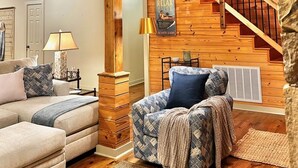 A spacious living area with a high ceiling, wooden staircase, and a cozy seating arrangement. - Lake Martin, AL
43 min to Auburn University & Jordan-Hare Stadium (Dadeville)