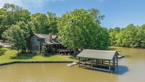 A house with a dock extending into a lake, surrounded by dense trees. - Lake Martin, AL
43 min to Auburn University & Jordan-Hare Stadium (Dadeville)