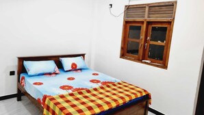 A bedroom with a bed, a window, and an air conditioning unit. - New 5 bed Room Villa (Piliyandala)