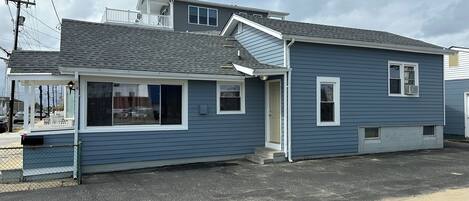 A two-story house with a covered porch and a garage.
