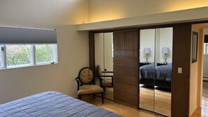 A bedroom with a bed, a chair, a wardrobe, and a mirror. - Gorgeous home w/Sauna downtown Anchorage. Walk to dine, coffee & attractions (Anchorage)