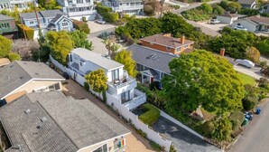 A residential area with houses, a driveway, and a street. - 5BR Beach House | Hot Tub, Game Room + Studio (Summerland)