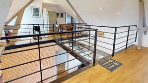 A multi-level interior with a glass bridge, wooden flooring, and a pool table. - Concorde Aérogare 25 people 2 Cottage : jacuzzi baby airhockey (La Haye-Pesnel)