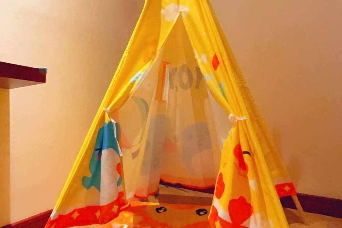 A yellow tent-like structure with a cartoon character design.