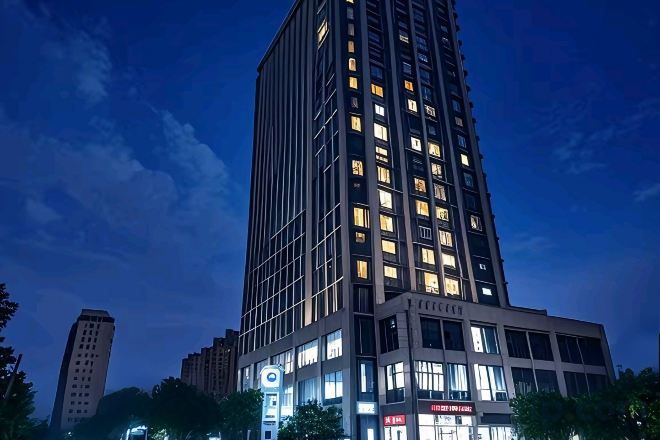A high-rise building with multiple floors, large windows, and illuminated signage.
