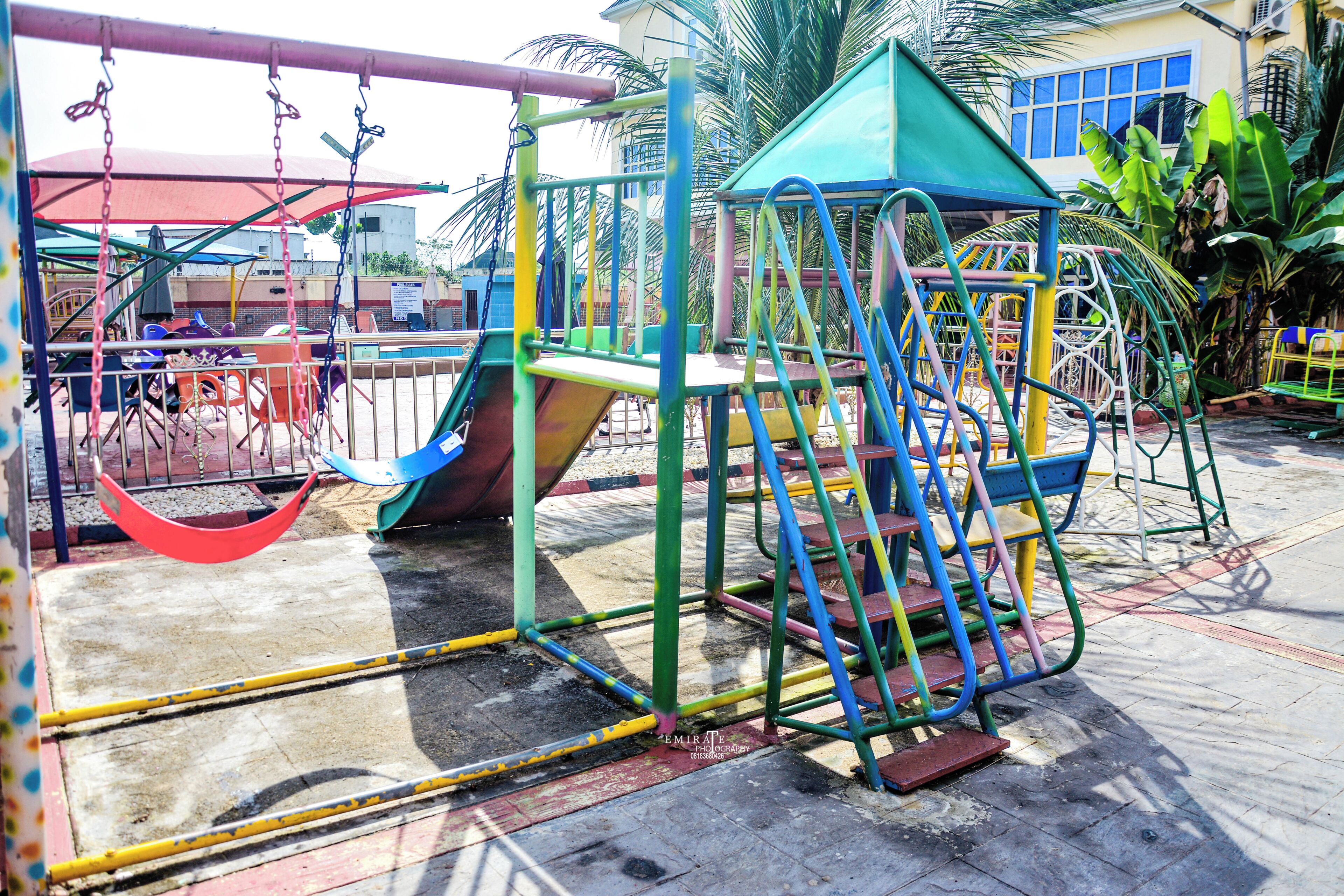 A playground with various play structures, including a slide and swings.