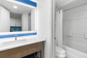 Bathroom features a sink, mirror, shower area, toilet, and bathtub.