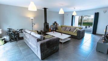 A modern living room with a sofa, coffee table, and a fireplace.