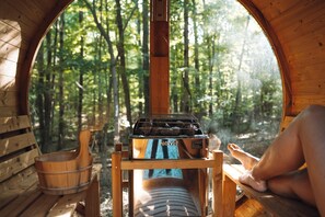 A wooden cabin with a circular window, a Harvia sauna, and a wooden bench. - Private Multi Family Retreat on 5 Acres! (Sewanee)