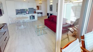 Un appartement moderne comprenant une cuisine, un coin repas et un salon.