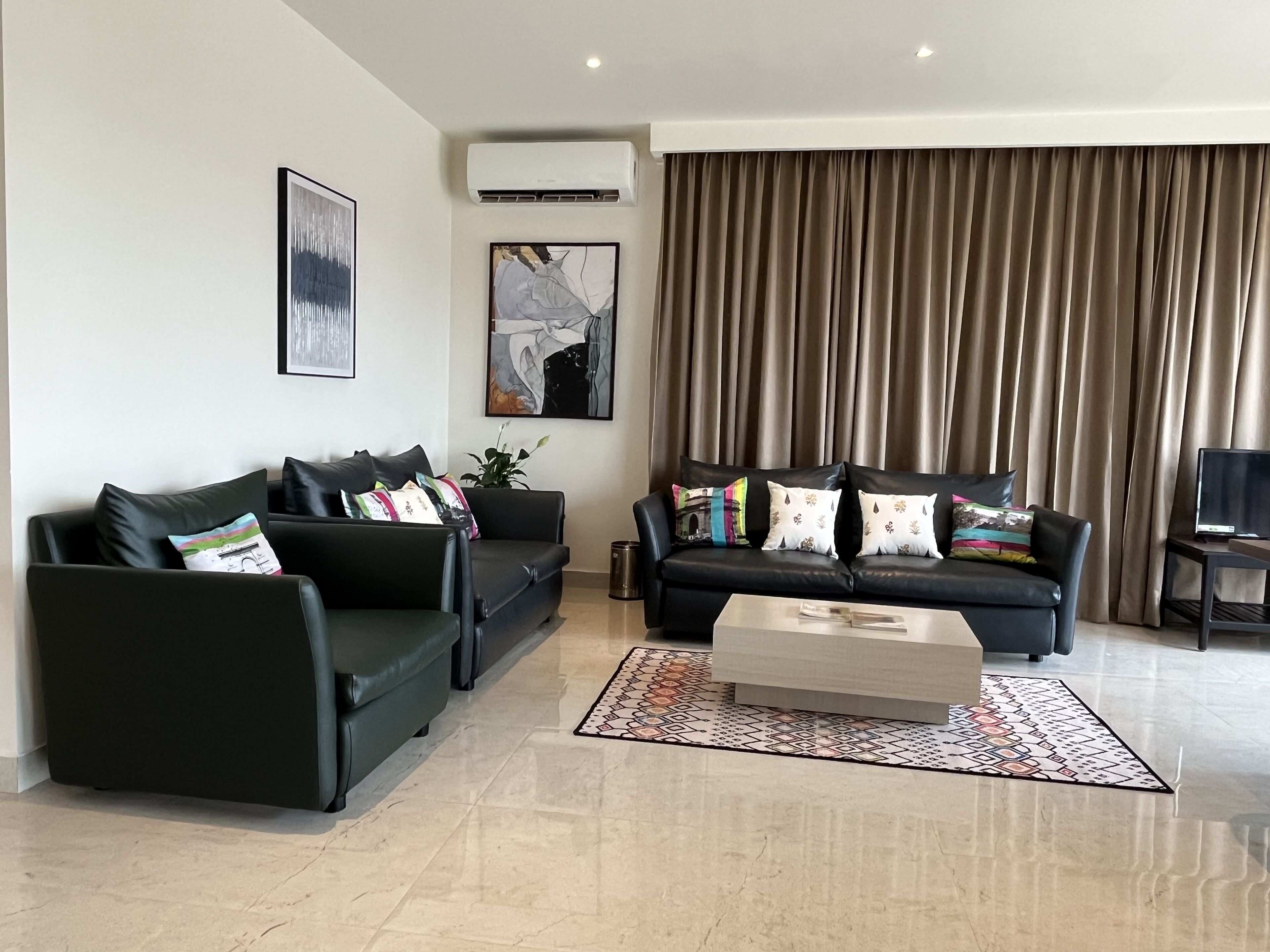 presidency airport view suite with free airport pickup/drop | living area | 81-cm smart tv with digital channels, pay films, streaming services