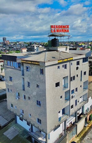 A multi-story building with a sign reading 'RESIDENCE LA MARINA APARTMENTS.' - Residence La Marina (Douala)